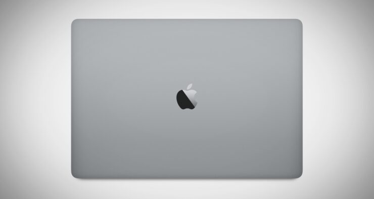 Silver laptop with shiny metallic bitten apple logo in the center